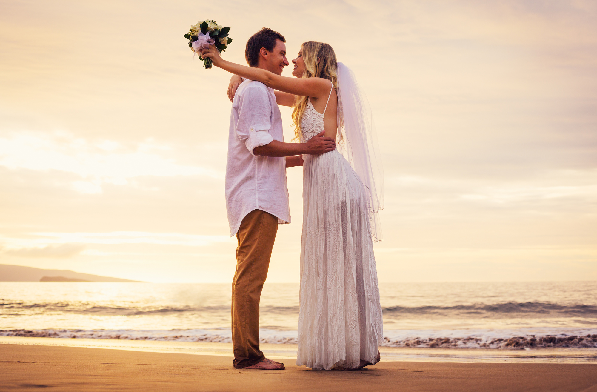 Bride And Groom On Beach At Sunset